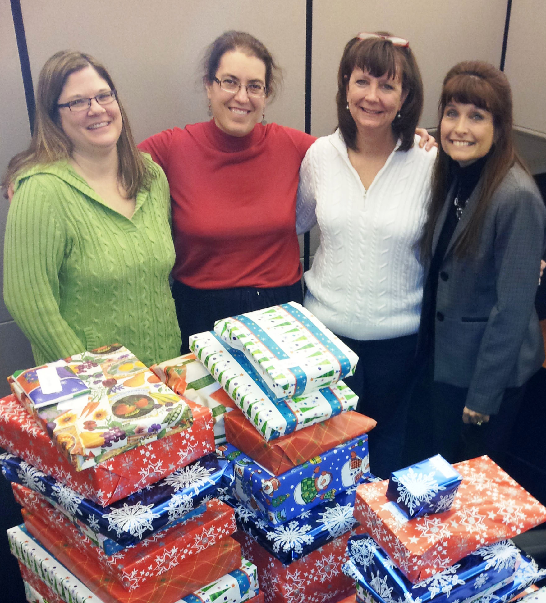 Staff members from the Office of Institutional Research and Planning pose with their donations for a Georgia Tech family in need. 